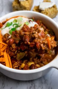 Simple vegan chili recipe, made with TVP, is warm and cozy like a bowl full of hugs! It’s a super easy and hands-off recipe that is perfect for meal prep or a busy weeknight dinner. Add everything to one pot and let it simmer. #vegan #veganchili #chili #plantbased // plantpowercouple.com