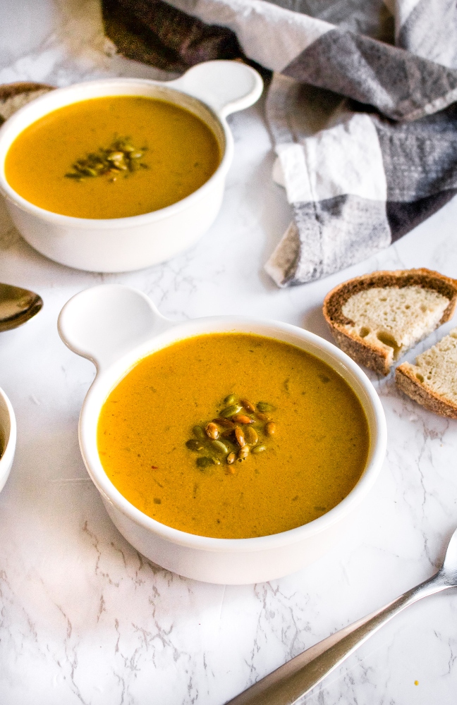 This savory curried pumpkin soup is an easy one-pot plant-based meal. Make it on the stove or in the slow-cooker with either canned pumpkin or fresh pumpkin and a few kitchen staples. It’s gluten-free, dairy-free (without coconut milk!), and includes an oil-free option. #vegan #pumpkinsoup #savorypumpkinrecipe