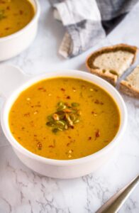 This savory curried pumpkin soup is an easy one-pot plant-based meal. Make it on the stove or in the slow-cooker with either canned pumpkin or fresh pumpkin and a few kitchen staples. It’s gluten-free, dairy-free (without coconut milk!), and includes an oil-free option. #vegan #pumpkinsoup #savorypumpkinrecipe