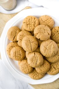 These vegan peanut butter cookies are made dairy-free and egg-free simply by using a flax egg! The decadent vegan cookies are beautifully crumbly and will legit melt in your mouth. They are easy to make - the perfect vegan peanut butter recipe for the holidays or any time of year!