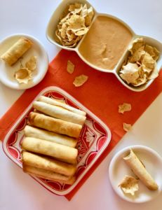 Vegan Taquitos! Make them in the air fryer or deep fryer. They're filled with spicy jackfruit meat and a killer dairy-free queso sauce. // plantpowercouple.com