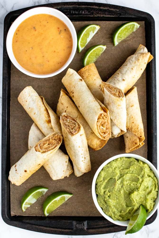 These crispy air fryer vegan taquitos are made with a meaty, flavorful jackfruit and refried beans filling with a quick dairy free queso sauce. This tasty vegetarian appetizer recipe is fun to make and is always a huge hit! Serve them with your favorite dips for a game day plant-based platter or for a cozy date night in. Or serve them with some rice and beans for a complete family dinner.