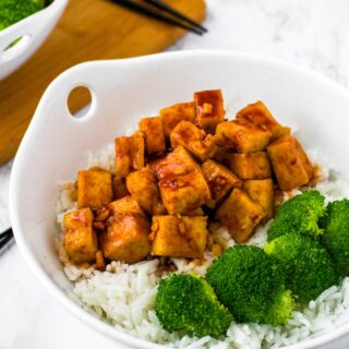 This easy air fryer tofu with a sweet sriracha sauce is our favorite quick tofu recipe! It’s perfect for a healthy weeknight dinner or meal prep lunch. Tofu is diced and air fried (with no oil needed!) and then tossed in a sweet and spicy sriracha sauce. Serve this sweet sriracha tofu recipe over rice and roasted veggies or in a vegetable stir fry!