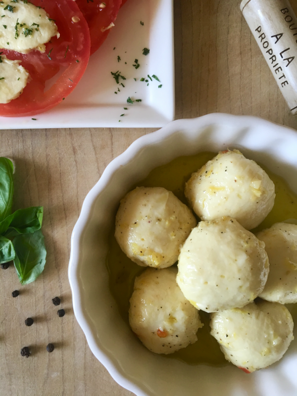 Lemon Pepper Marinated Vegan Bocconcin aka mozzarella balls. This vegan cheese recipe is so darn good! It slices, melts, and tastes great popped right into your mouth! // plantpowercouple.com
