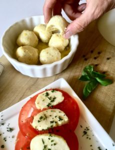 Lemon Pepper Marinated Vegan Bocconcin aka mozzarella balls. This vegan cheese recipe is so darn good! It slices, melts, and tastes great popped right into your mouth! // plantpowercouple.com