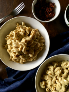 Creamy vegan roasted garlic sauce that is completely dairy-free and VEGAN! No cashew-soaking required, just roast your garlic, blend the ingredients, and pour over pasta! // Recipe from plantpowercouple.com