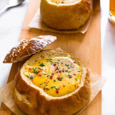 This cozy vegan beer cheese soup is nut-free and tastes like actual beer cheese soup, not just a healthy version of it! Surprisingly though, this cozy soup is dairy-free, easy to make gluten-free, and includes an oil-free option along with some sneaky hidden veggies. Make it for your Oktoberfest feast at home with ALL the German beers! #vegansoup #vegancheese #veganbeercheese #plantbased #veganrecipe #easyveganrecipe