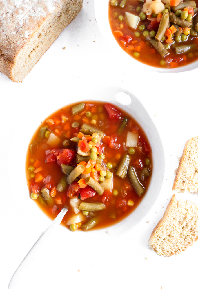 Make this Homestyle Vegetable Soup to brighten any sick or rainy day! It's so crazy simple yet full of flavor and comfort, just like the Campbell's soup we all grew up loving but made at home! Vegan + Gluten-free too. #vegan #glutenfree #soup #vegetablesoup #veganrecipes #plantbased // plantpowercouple.com