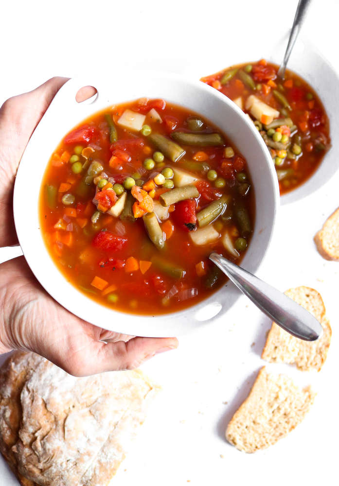 Make this Homestyle Vegetable Soup to brighten any sick or rainy day! It's so crazy simple yet full of flavor and comfort, just like the Campbell's soup we all grew up loving but made at home! Vegan + Gluten-free too. #vegan #glutenfree #soup #vegetablesoup #veganrecipes #plantbased // plantpowercouple.com