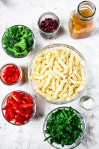 Overhead photo of all the ingredients you need to make vegan pasta salad