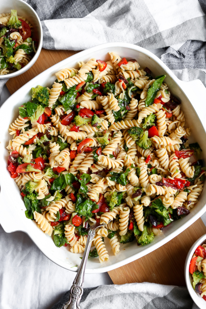 This simple vegan pasta salad recipe is a “grown-up-riff” off the traditional side dish my Gram used to make for me at ALL the family BBQs + parties. It’s quick, easy to make and bursting with flavors of fresh veggies like red peppers, tomatoes, kalamata olives, and more! #vegan #plantbased #recipe #summer #sidedish // plantpowercouple.com