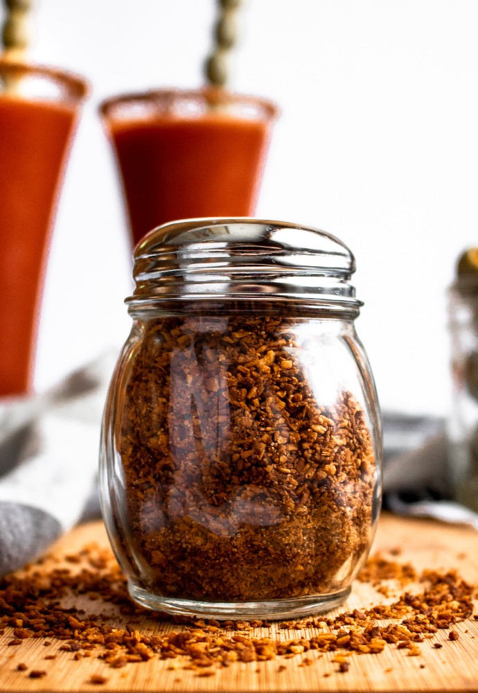 Level-up your cocktail game with this Vegan Bloody Mary Bacon Salt! Made from marinated coconut, this crumbly vegan bacon topping is perfect for your morning tofu scramble or lining the rim of your Bloody Mary cocktail. #vegan #coconut #bacon #veganbacon #plantbased // plantpowercouple.com