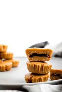PB + J meets peanut butter cup in this killer combo of classic comfort foods! These delightful PB+J Cups are easy to make with only 4 ingredients, simple methods, and no heat required. They’re the ultimate summer sweet for your kids or the kid in us all! #vegan #dairyfree #vegancandy #veganrecipes #glutenfree //plantpowercouple.com