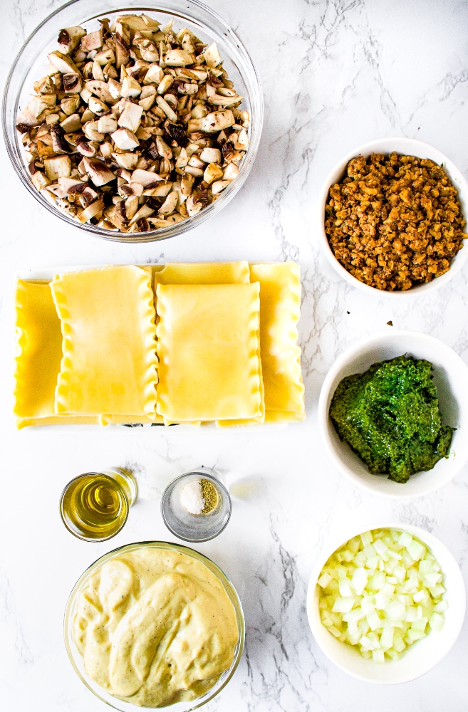 Overhead shot of ingredients you need to make creamy vegan mushroom lasagna with dairy free pesto and sausage style walnut meat