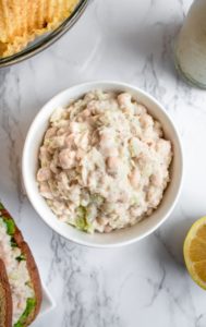 This vegan tuna salad is a simple recipe, using white beans and a few other common ingredients you probably have around the house + one *magic* ingredient to create the flavor + texture of a classic tuna sandwich! #vegan #tuna #vegantuna #lunch #veganlunch #beans #plantbased #navybeans #whitebeans