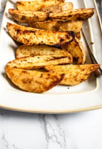 These cast iron potato wedges recipe is easy to make, super dependable, and can be altered to your specific spice/flavor desires. A healthier alternative to french fries, they’re great paired with ALL your summer grilling favorites or just as a snack served with ALL the dips! #vegan #potatoes #potatowedges #plantbased #castiron #comfortfood #veganrecipe