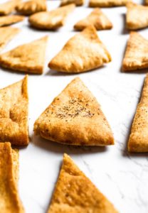 Make your own pita chips in the air fryer with just 4 ingredients and 20 minutes of your time! Perfect for snacking or dipping in hummus. #vegan #veganrecipe #airfryer #airfryerrecipes #pitachips #easyveganrecipes #vegansnack #homemade