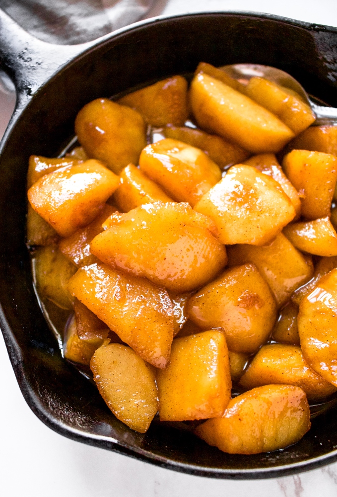 These vegan sauteed cinnamon apples are made on the stovetop and the best topping for pancakes, waffles, or ice cream. These dairy-free sauteed apples are gluten-free, include a low-sugar option, and taste like warm apple pie filling with just 5 simple ingredients. Our favorite way to use up excess apples!