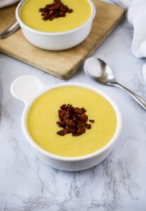This creamy vegan potato soup recipe is easy to make right in your Vitamix or other high-powered blender! It’s the BEST dairy-free potato soup we’ve ever eaten - loaded with flavor, a thick creamy texture, and soul-warming from start to end. Load it with your favorite toppings like vegan bacon and cheese or sip it out of a mug on a cold winter day!