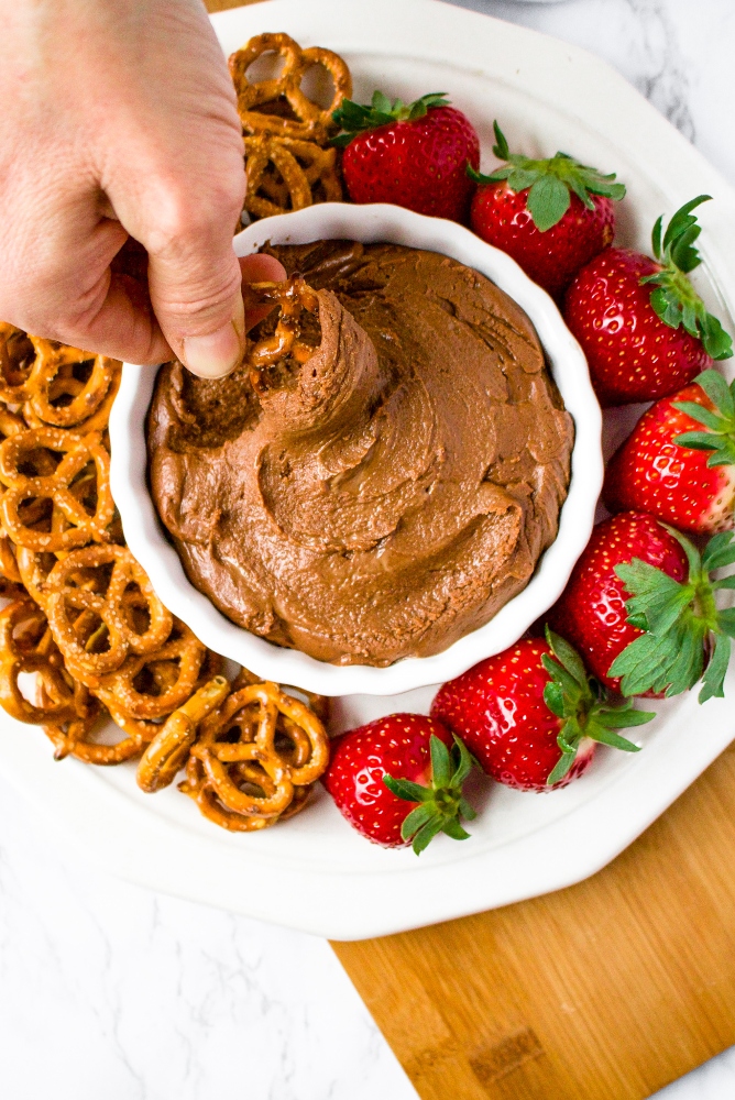 If you’re looking for an easy Valentine’s Day dessert you can whip up in under 10 minutes but is still sure to impress and make you feel indulgent, we have the recipe for you! This Vegan Brownie Batter Dip is our favorite tahini-based dessert dip. Serve it on a platter with pretzels and strawberries for date night or any time you really want a wow-factor! This is an amazing (ps: it’s also healthy) tahini dessert, and if you’ve never tried tahini in a dessert before, get ready for your life to change.
