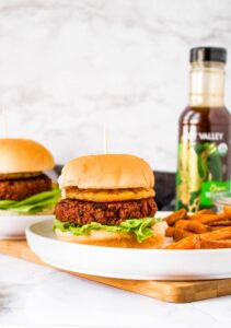 This Hawaiian-inspired vegan teriyaki burger is the meatiest and tastiest on the planet! If you love teriyaki chicken, you’re going to love this plant-based homemade burger! It starts with a blend of TVP and vital wheat gluten with a little beet puree thrown in for a meaty color. Then, it’s flavored with the perfect blend of garlic, ginger, red onion, and teriyaki sauce. It’s topped with a grilled pineapple slice and spicy teriyaki mayo. It’s a great vegetarian option for cookouts and guaranteed to be your new favorite summer veggie burger.