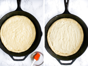 Vegan white pizza step 3: ASSEMBLE THE PIZZA: Use your hands to flatten the pizza crust into a cast iron pan and brush the whole crust lightly with olive oil. Then, spread a layer of the vegan white sauce on the pizza crust, leaving some room for the crust around the edges.