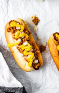The Coney Dog is an American classic -- a hot dog topped with an all-meat mustard chili and diced onions. This vegan coney dog recipe is just as perfect for a weekend BBQ with friends as it is a weeknight family dinner at home with the kids. Easy and quick to make, you’ll love this vegetarian chili topping more and more with every delicious bite. This is not just a simple chili dog; this is a Coney Dog!