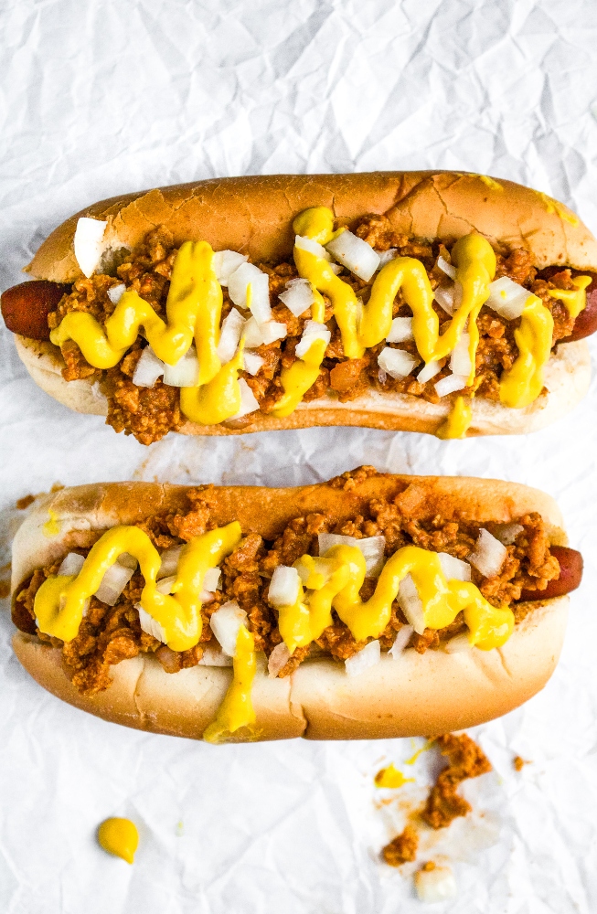 The Coney Dog is an American classic -- a hot dog topped with an all-meat mustard chili and diced onions. This vegan coney dog recipe is just as perfect for a weekend BBQ with friends as it is a weeknight family dinner at home with the kids. Easy and quick to make, you’ll love this vegetarian chili topping more and more with every delicious bite. This is not just a simple chili dog; this is a Coney Dog!