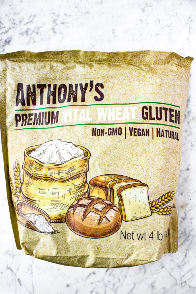 Overhead shot of a bag on vital wheat gluten for making seitan. Text on the bag reads: Anthony's premium vital wheat gluten, non-gmo / vegan / natural