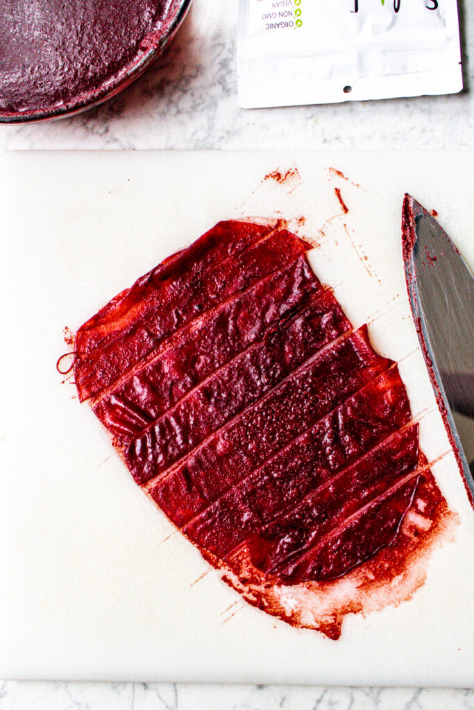 Overhead view of marinated rice paper sliced in strips on a cutting board