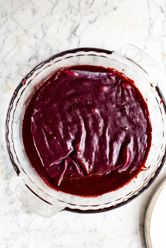 Overhead view of a sheet of rice paper marinating in a pie plate