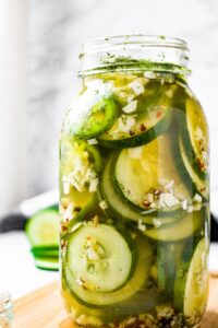 Head on shot of a large 32 oz mason jar filled with homemade refrigerator pickles