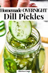 Overhead shot of a hand pulling a pickle slice out of a large mason jar. There are sliced cucumbers in the background. Text reads: homemade overnight dill pickles