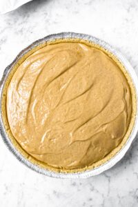 Overhead shot of a vegan graham cracker crust filled with a dreamy peanut butter white chocolate filling