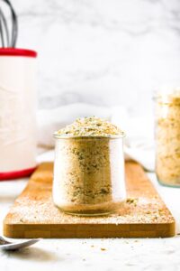 Head on photo of a clear glass jar filled with homemade Italian bread crumbs