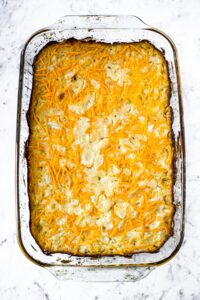 Overhead photo of a dish of vegetarian hashbrown casserole after baking in the oven