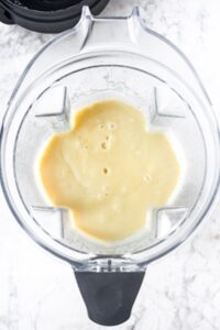 Overhead shot of an open Vitamix with cream potato soup in it