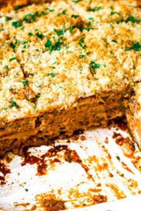 Overhead close up shot of plant-based zucchini lasagna showing the layers of tofu ricotta and saucy tvp beef.