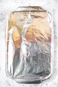 Overhead shot of a casserole dish covered in aluminum foil