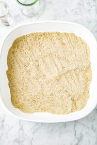 Overhead shot of a large square white baking dish filled with breadcrumbs
