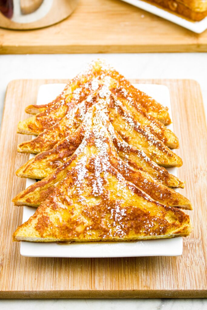 Overhead photo of a plate of triangular French toast with powdered sugar on top