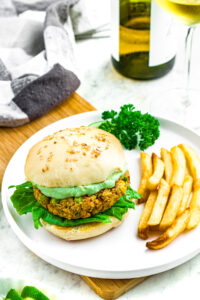 Overhead photo of a vegan california burger on a plate with a side of french fries