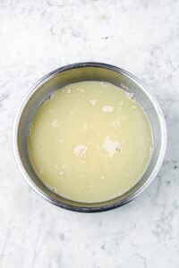 Overhead photo of a bowl with water and blooming yeast
