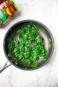 Overhead photo of a pan with sauteed garlic spinach in it