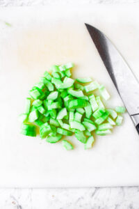 Overhead photo of diced cucumber on a cutting board