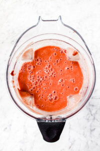 Overhead photo of blended fresh tomatoes in an open Vitamix