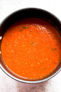 Overhead photo of a large pot of pasta sauce made from fresh tomatoes