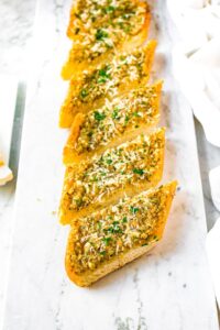 Overhead photo of a row of vegan garlic bread slices