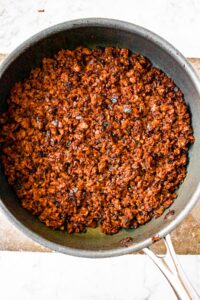 Overhead photo of browned vegan mince in a round black pan