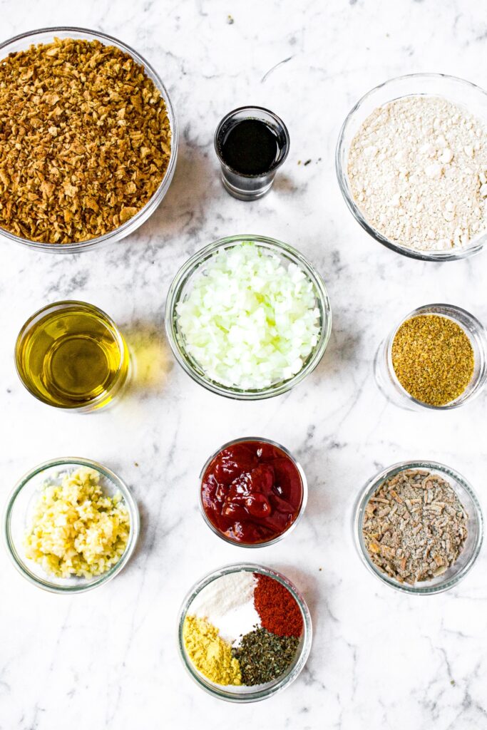Overhead photo of all the ingredients you need to make a TVP meatloaf in separate bowls